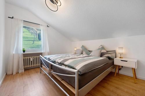 a bed in a room with a window and a bed sidx sidx sidx at Ferienwohnung Kraft in Bad Wildbad