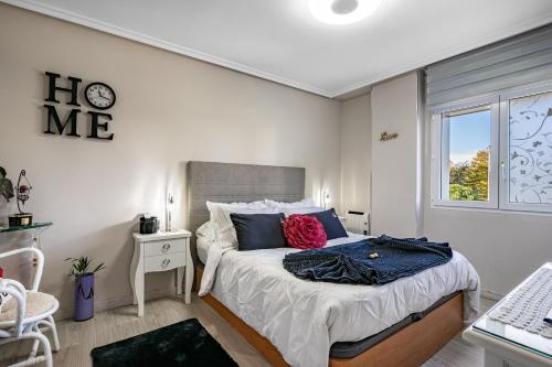 a bedroom with a bed with a clock on the wall at Rincón De Julia in Gijón