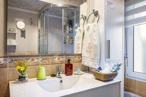 a bathroom with a sink and a mirror at Rincón De Julia in Gijón