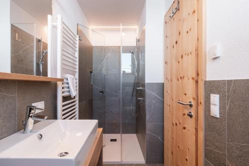 a bathroom with a sink and a shower at Huberhof Gais in Gais