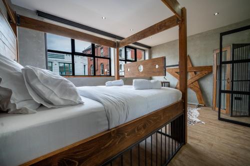 a large bed in a room with a large window at LV8 Chesterfield in Chesterfield