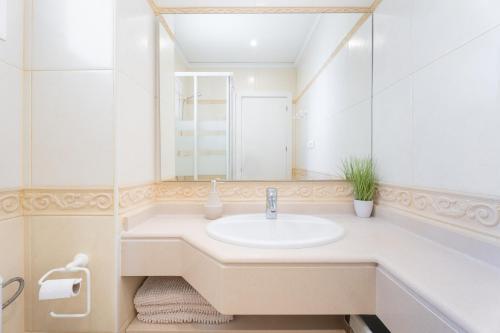 a bathroom with a sink and a mirror at Mont Pele in Cullera