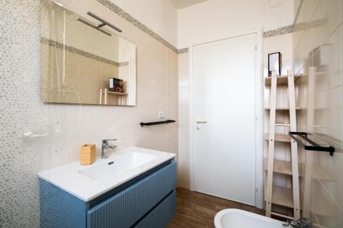 a bathroom with a sink and a mirror at Golden Bay Lux House in Torre Lapillo