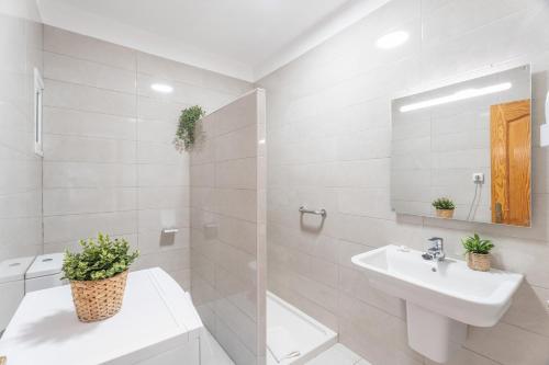 a white bathroom with a sink and a mirror at Infinity Pool Views 2 Las Floritas in Playa de las Americas