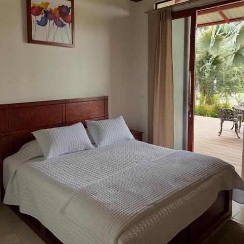 a bedroom with a bed and a sliding glass door at La Quinta de Andrés in San Isidro