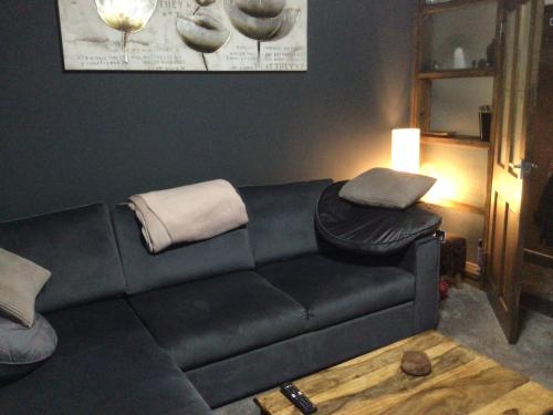 a black couch in a living room with a lamp at City apartment no.8 in Norwich
