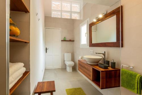 a bathroom with a sink and a mirror at Villa Torre Xanchu in Sant Josep de sa Talaia