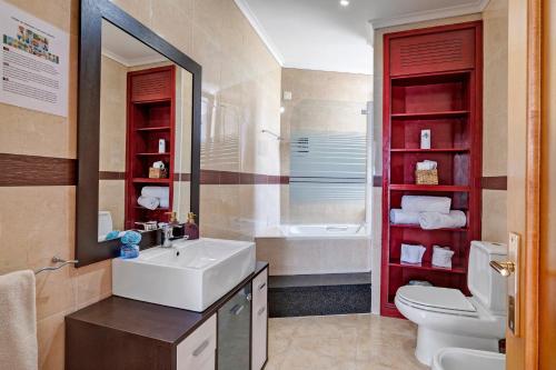 a bathroom with a sink and a toilet and a tub at Archer'shouse - Olival's Treasure in Olival