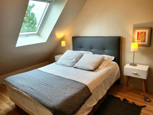 a bedroom with a large bed and a window at Villa Des Havres in Saint-Germain-sur-Ay