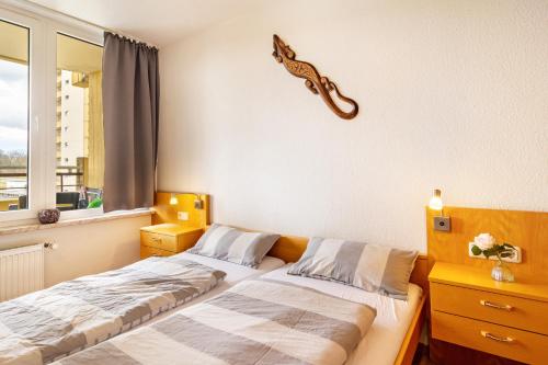 a bedroom with two beds and a guitar on the wall at Gemütliche Fewo im schönen Harz in Braunlage