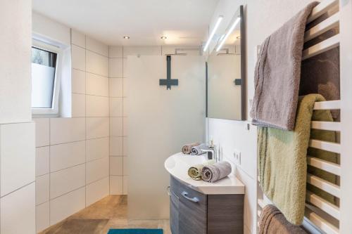 a bathroom with a sink and a shower at Haus Florian Ski-in and Ski-out in See