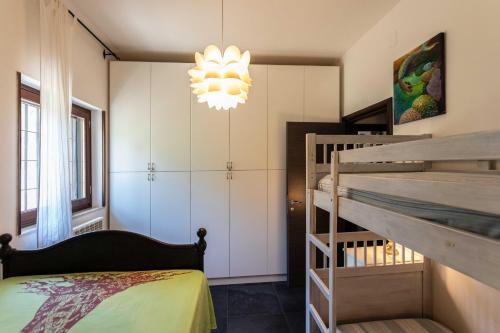 a bedroom with a bunk bed and a chandelier at Villa Sole With Pool and Sauna in Lecce
