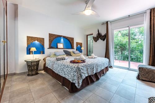 a bedroom with a bed and a large window at Art Gallery House in La Cala de Mijas