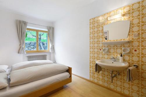 a bedroom with a bed and a sink at Unterzerunhof 2 in Laion