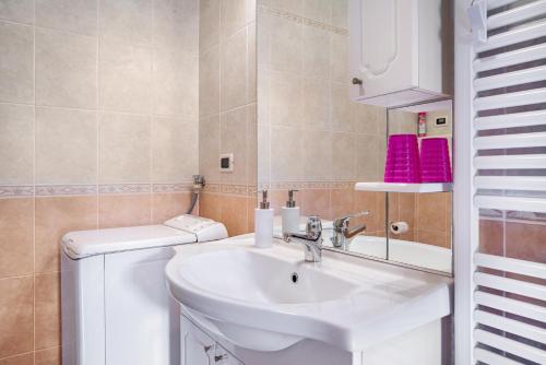 a bathroom with a sink and a toilet at Apartment Villa Irma in Levico Terme