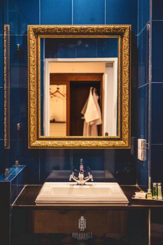 a bathroom with a sink and a mirror at Koranaree Courtyard Boutique Hotel in Nakhon Ratchasima