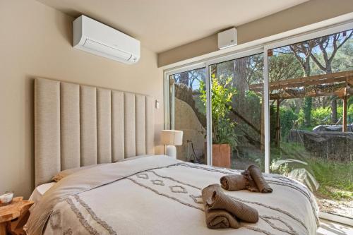 a bedroom with a bed with two slippers on it at Le Cocon Blanc - T3 - Gassin in Gassin
