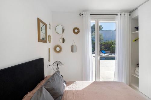 a bedroom with a bed and a sliding glass door at Blava in Begur
