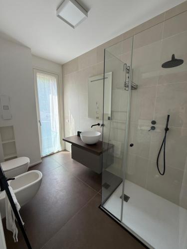 a bathroom with a glass shower and a sink at Residenza San Rocco in Pedemonte