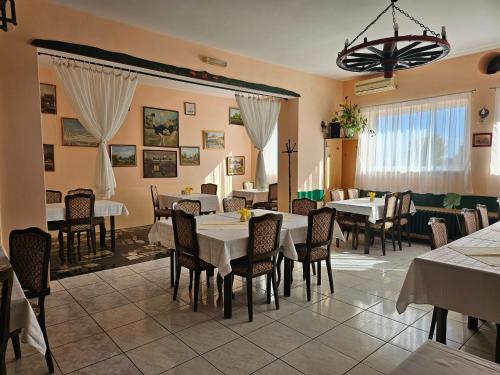 a dining room with white tables and chairs at Guljaš Čarda Old in Šupljak