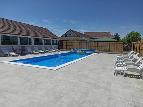 a swimming pool with lounge chairs and a swimming pool at Guljaš Čarda Old in Šupljak