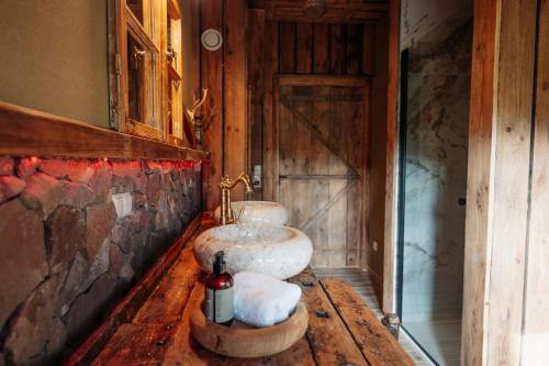 a bathroom with two sinks on a wooden table at Villa Sand in Bad Emstal