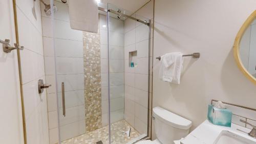 a bathroom with a shower with a toilet and a sink at 79 Meadow House in Sunriver