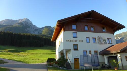 a large white building with a brown roof at Bauernhof Ober in Birnbaum