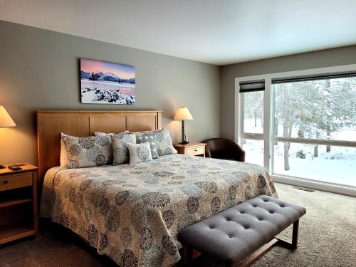 a bedroom with a bed and a large window at 73 Meadow House in Sunriver