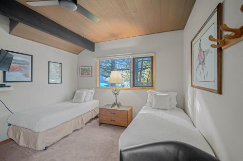 a bedroom with two beds and a window at 76 Meadow House in Sunriver