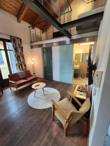 a living room with a couch and a table at Urban Loft Duomo in Alba