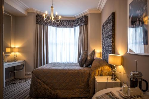 a hotel room with a bed and a window at York House Hotel in Whitley Bay