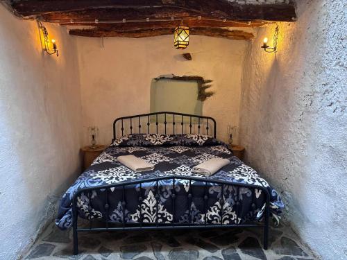 a bedroom with a bed in a small room at Casa Buena Vista in Ugíjar