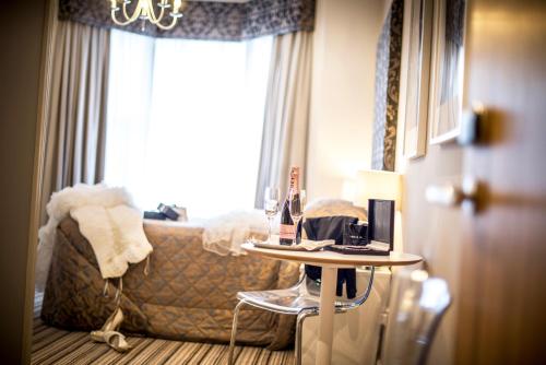 a room with a couch and a table with a lamp at York House Hotel in Whitley Bay