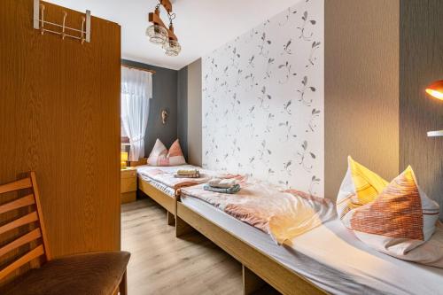 a bedroom with two beds and a wall with butterflies at Haus Dreeßen in Buchholz