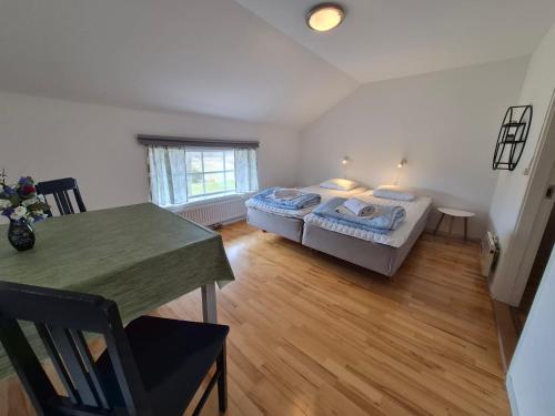 a bedroom with a bed and a table in it at Granbergs Gästhem in Eckerö