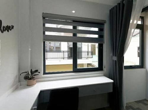 a window in a room with a potted plant next to it at Sky Home in Da Lat