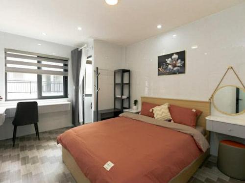 a bedroom with a bed and a desk and a mirror at Sky Home in Da Lat