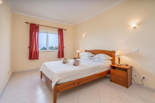 a bedroom with a large bed and a window at Villa Marachique 205 in Alvor