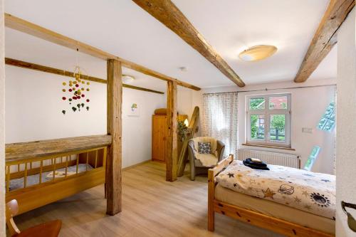 a bedroom with two bunk beds and a chair at Ferienwohnung Gartenfreude in Veckenstedt