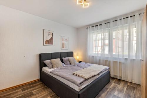 a bedroom with a bed and a large window at Fewo45 in Homberg