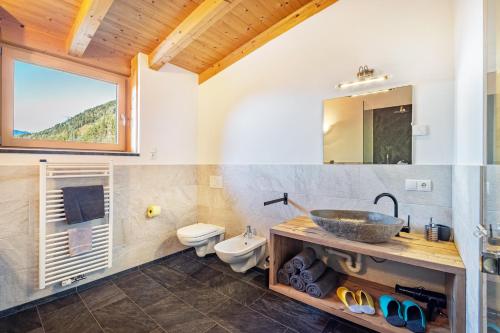 a bathroom with a sink and a toilet at Kreuzplonhof Apt Karspitz in Luson