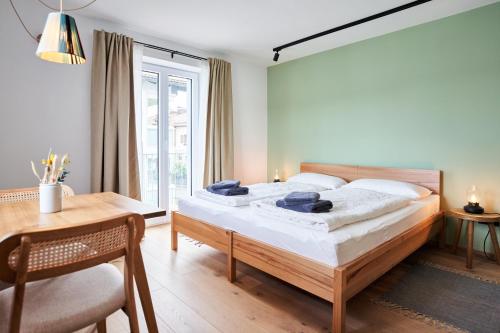 a bedroom with a bed and a table and a desk at Alte Seifensiederei - Jane in Bad Tölz