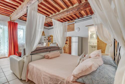 a bedroom with a bed with white curtains at Nido d'amore in Portoferraio