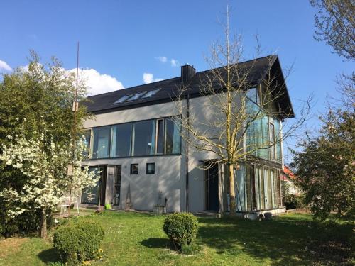 a house with a lot of windows on a yard at Falterweg in Immenstaad am Bodensee