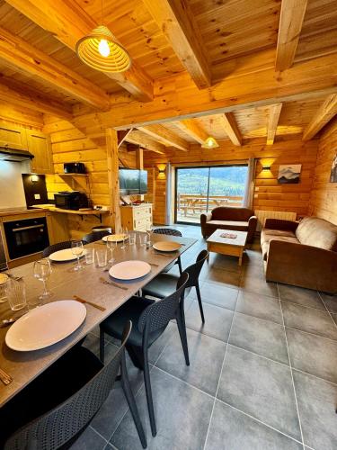 a dining room and living room with a table and chairs at la brume des cimes in Bussang