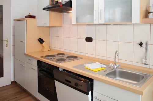 a kitchen with a sink and a stove at Ferienwohnung Jule in Sonthofen