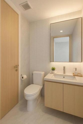 a bathroom with a toilet and a sink and a mirror at Perfect Location Direct Skywalk to BTS Thong in Bangkok