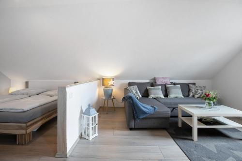 a living room with a couch and a bed at Ferienwohnung Huus 39 in Ostenfeld