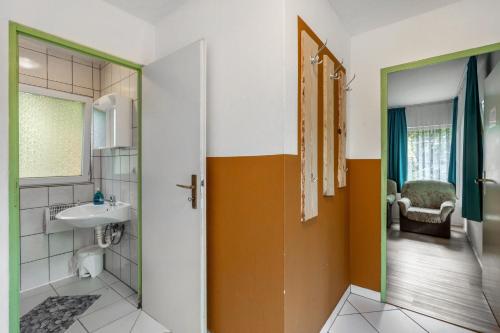 a bathroom with a toilet and a sink at Bungalow 15 - Finnhütte in Niesky